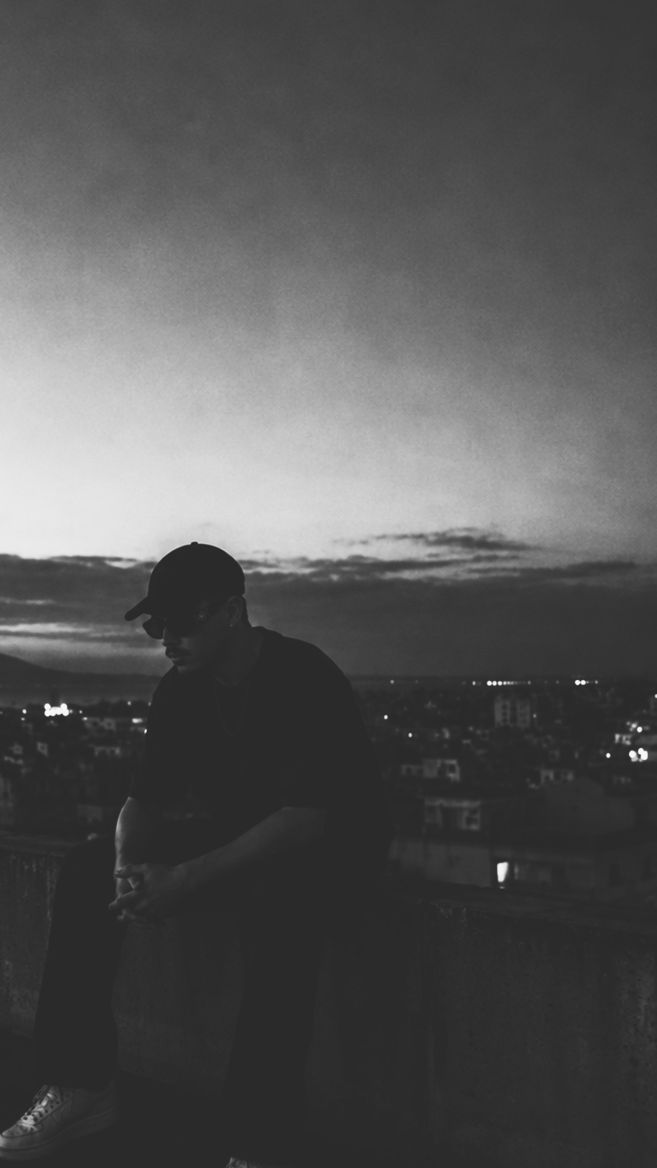 ABERCI artist portrait overlooking Barcelona skyline in black and white